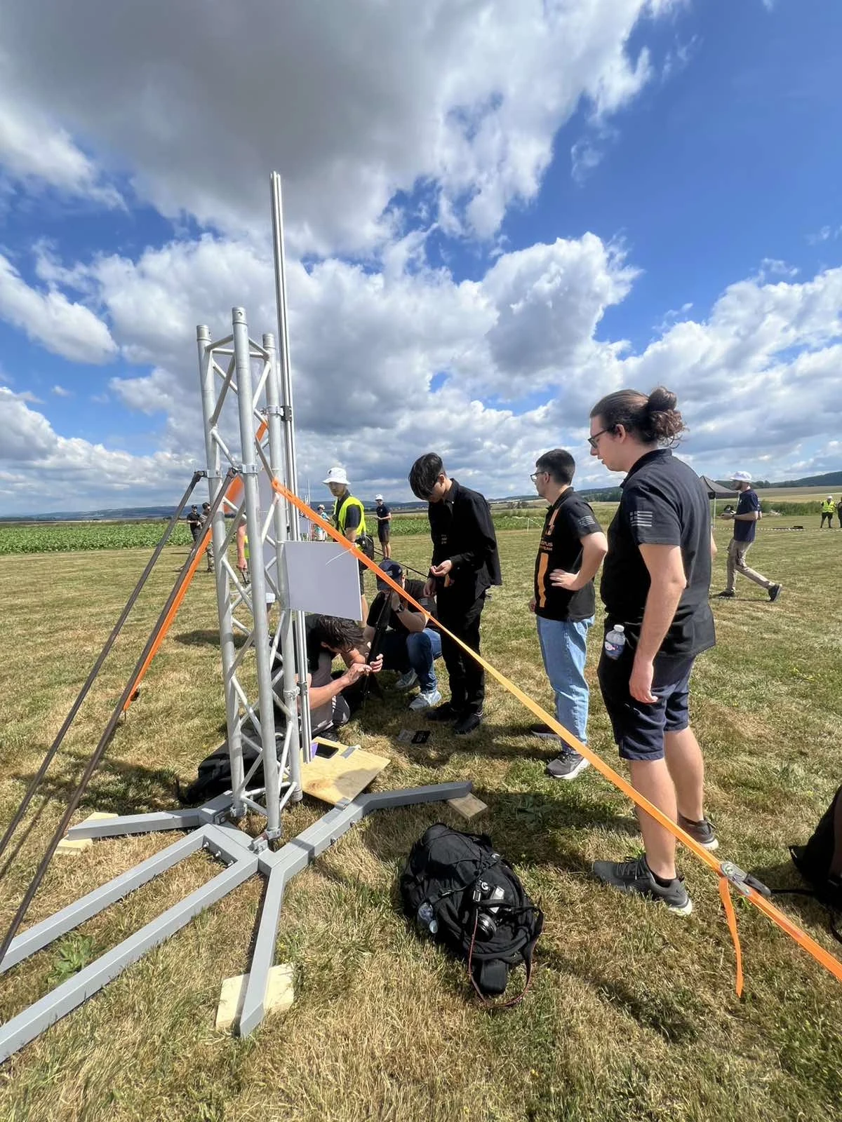 HEPHAESTUS members prepare the rocket beside the launch rail