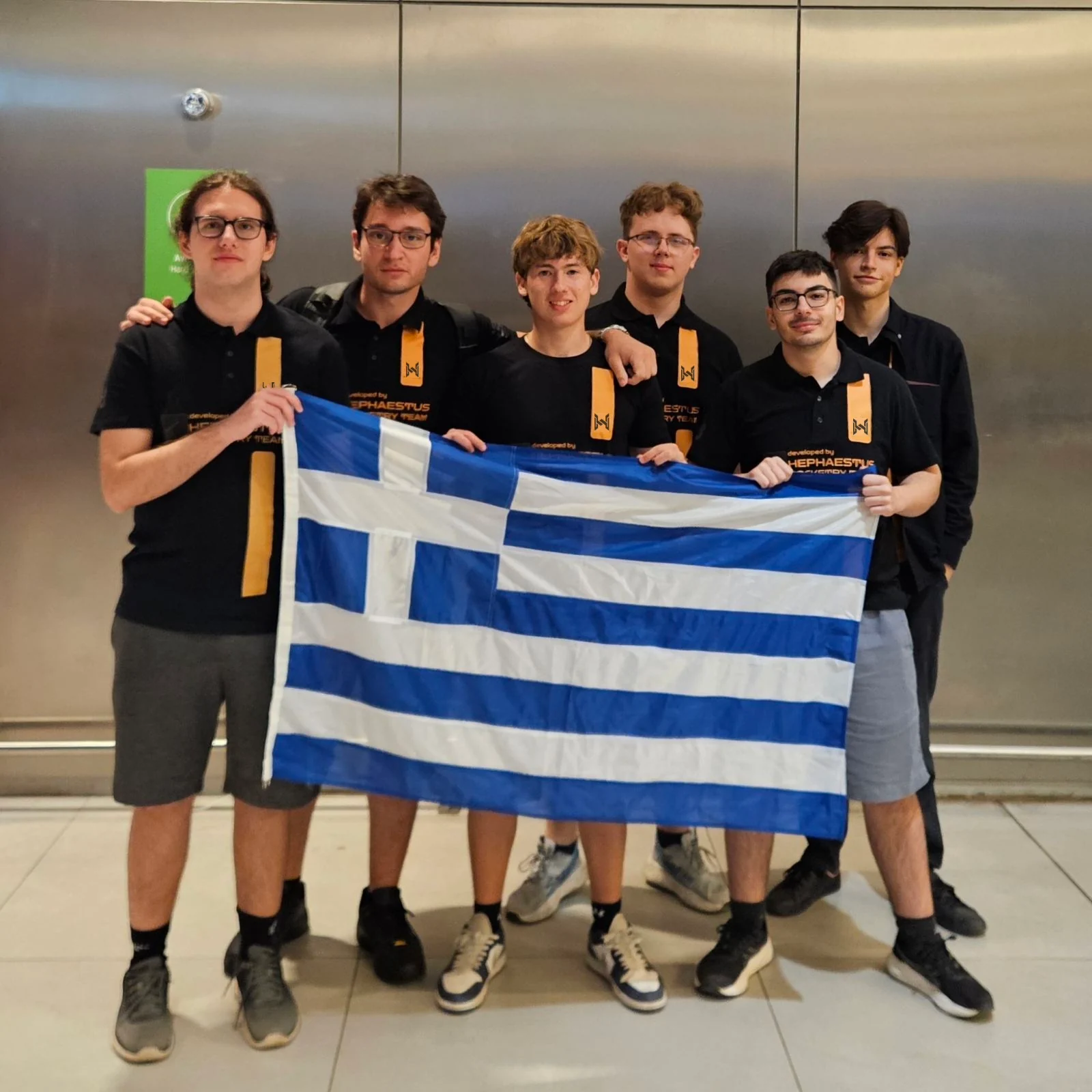 HEPHAESTUS members with the Greek flag on the SARISSA mission